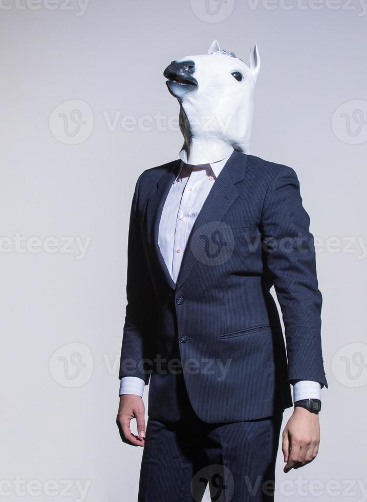 man with a horse mask on a light background photo