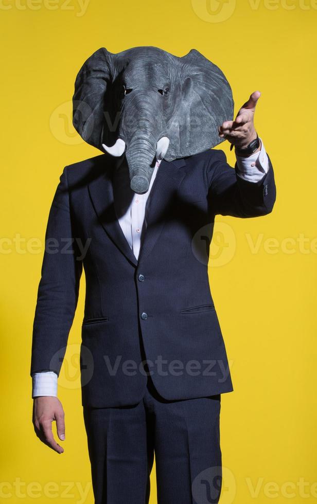 man with an elephant mask on a yellow background photo