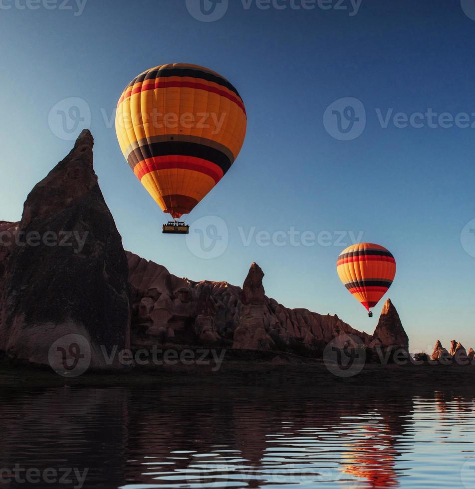Composition of balloons over water and valleys, gorges, hills, b photo