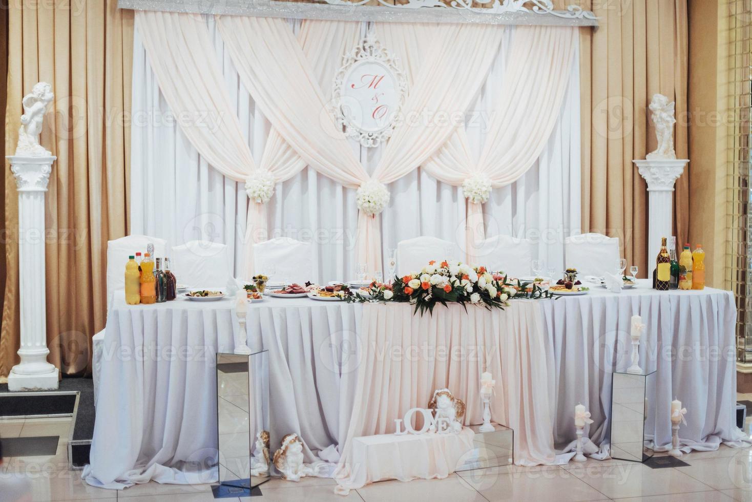 luxury decorated main table in the wedding hall photo