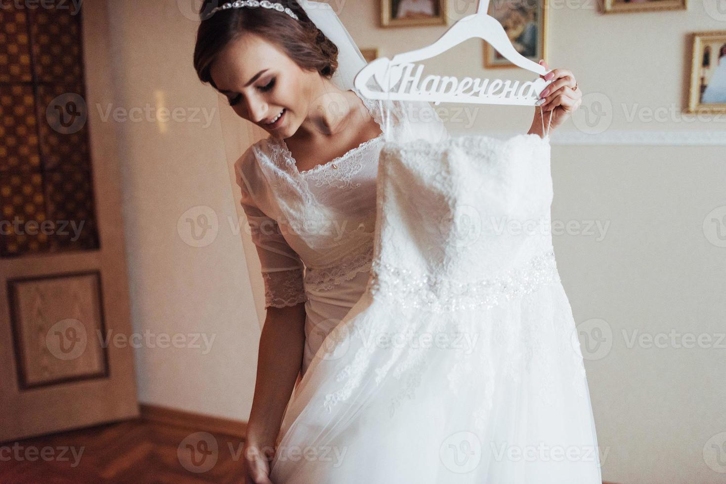 girl trying on wedding dress photo