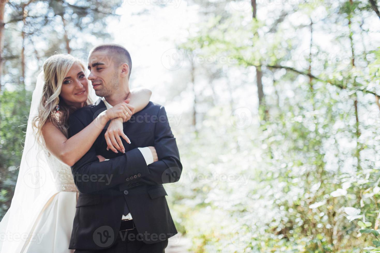 groom at a park on their wedding day photo