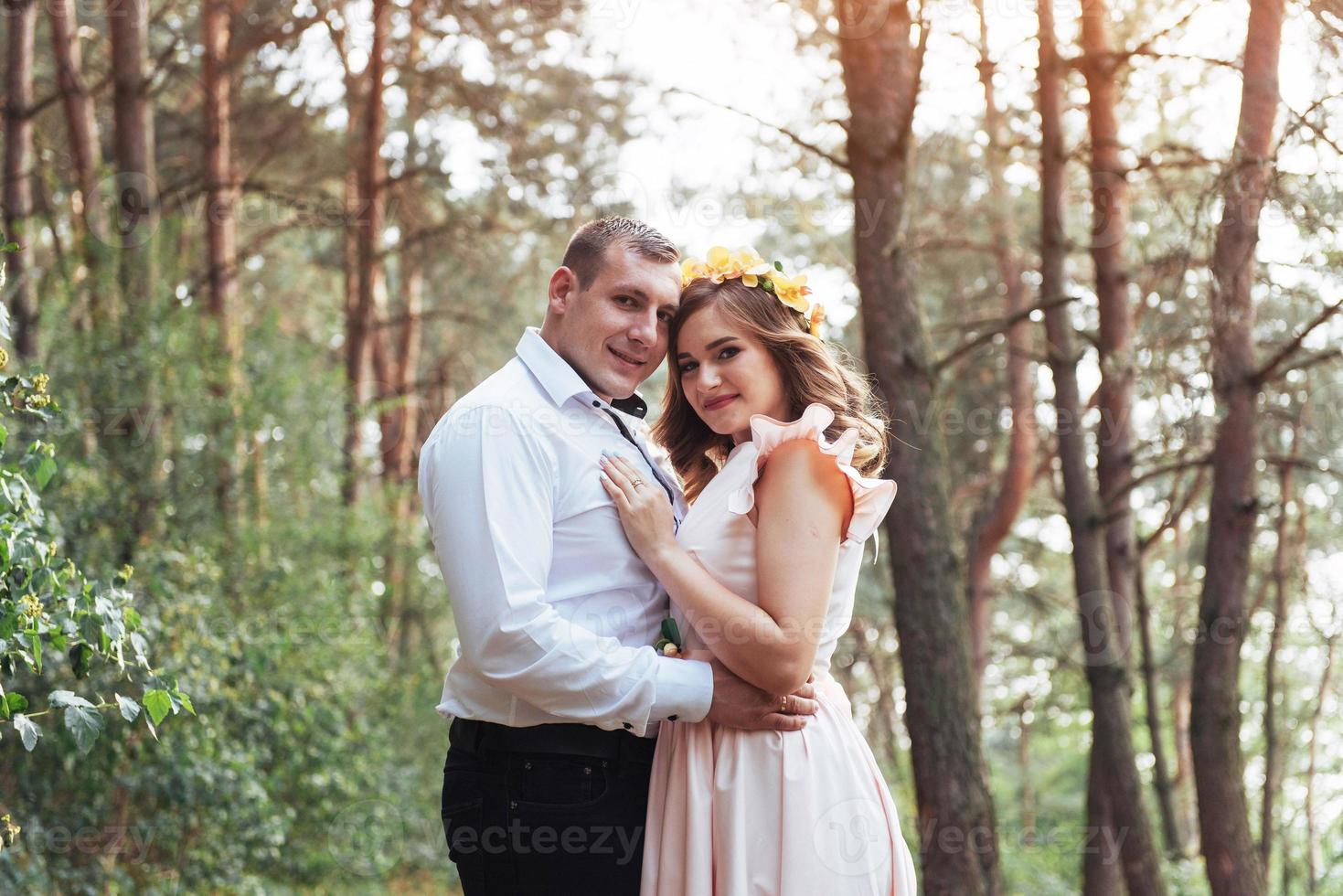 Happy couple in a pine forest Beauty world photo