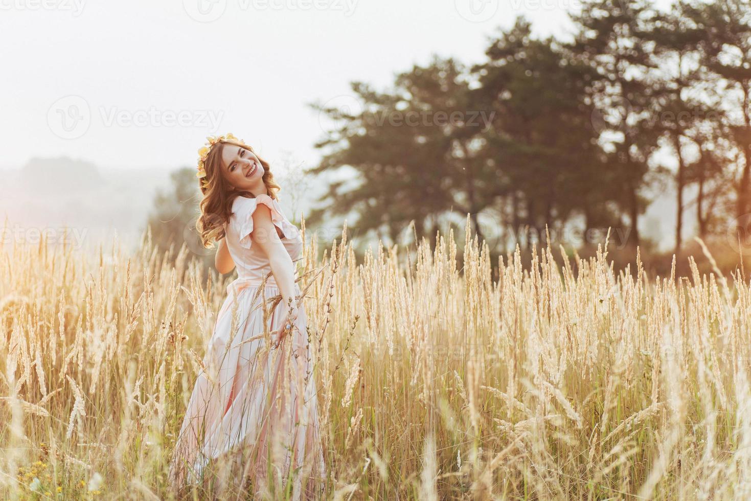 Beautiful happy girl in a wreath on his head photo