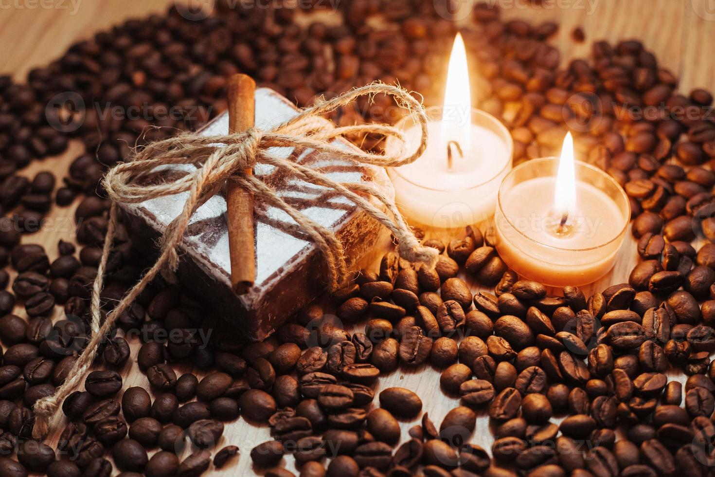 Burning aromatic coffee candle and beans, close-up photo