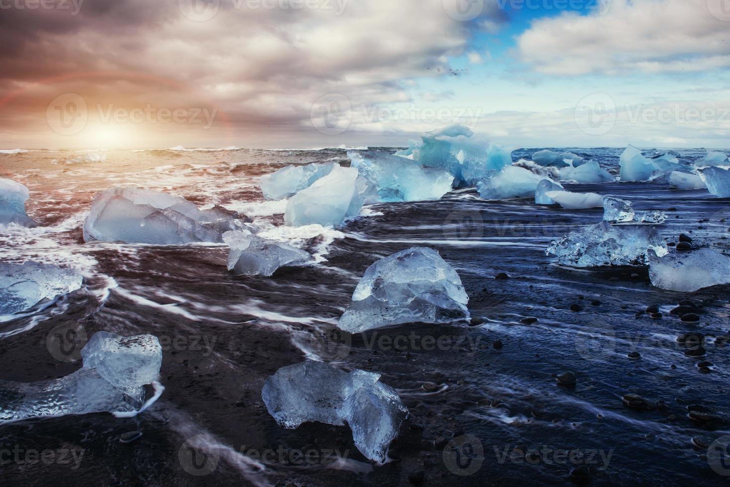 Jokulsarlon glacier lagoon fantastic sunset on the black beach, photo