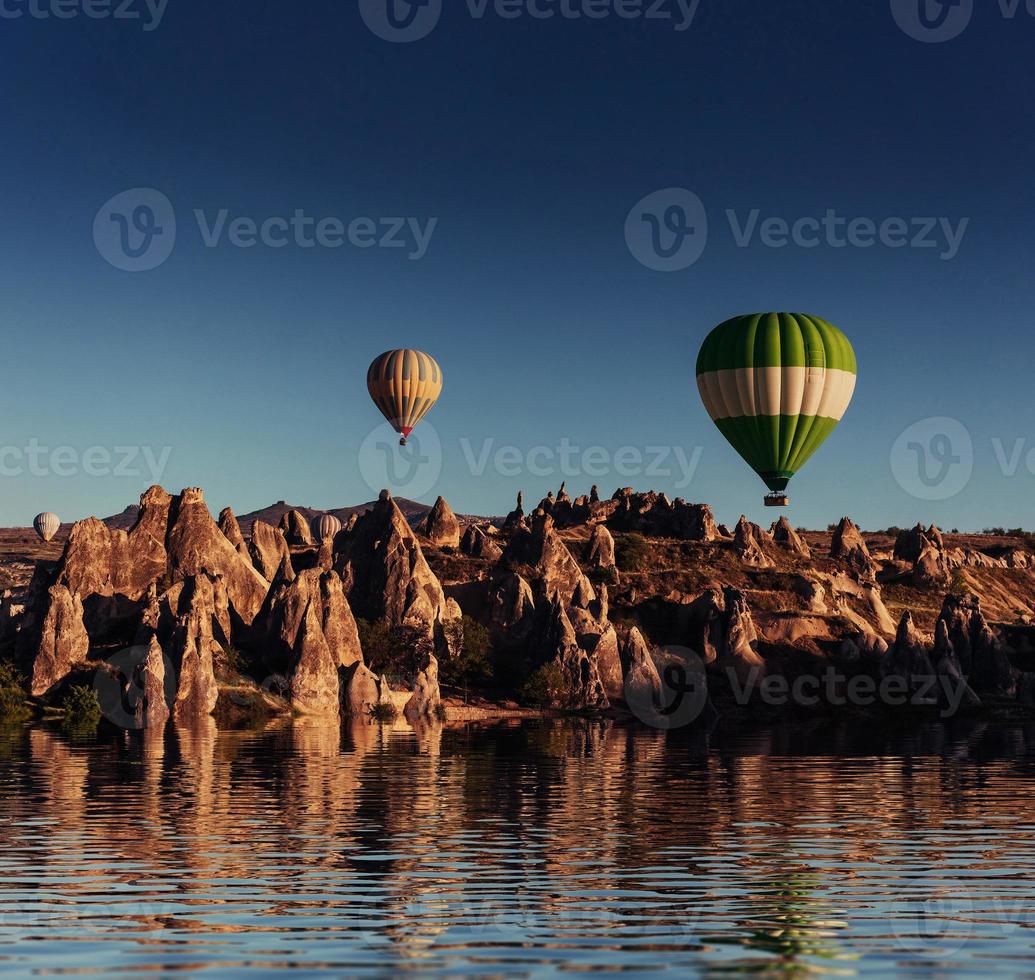 Composition of balloons over water and valleys, gorges, hills, b photo