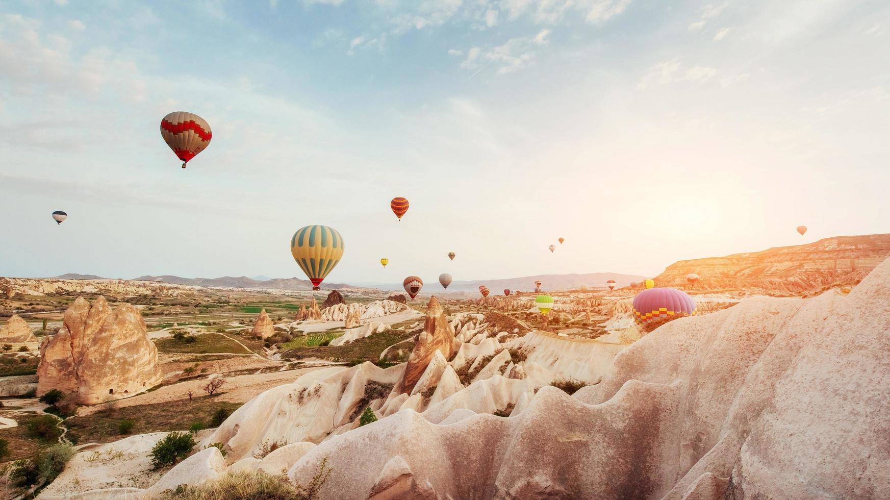 Hot air balloon flying over rock landscape at Cappadocia Turkey. photo