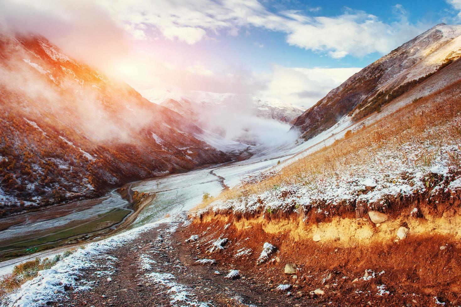 Mountain landscape of snow-capped mountains in the mist photo
