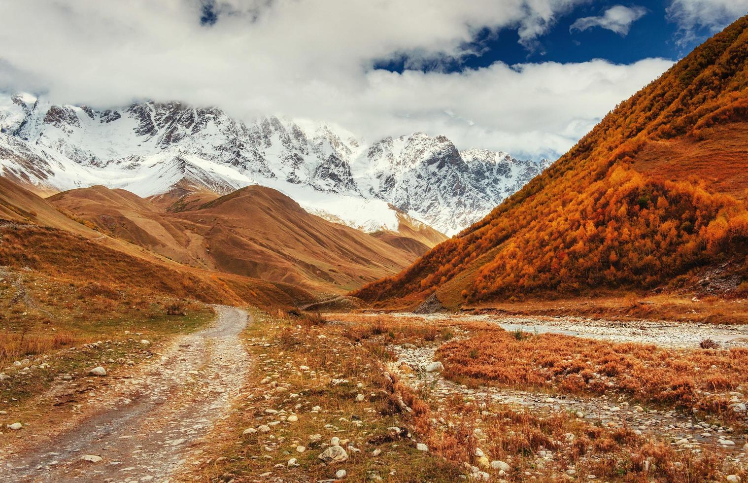 Mountain landscape of snow-capped mountains in the mist photo