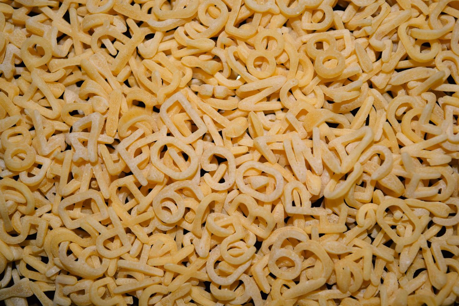 background of small vermicelli in the form of an alphabet photo