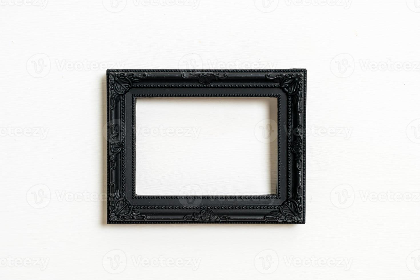 empty picture frame on white wall background photo