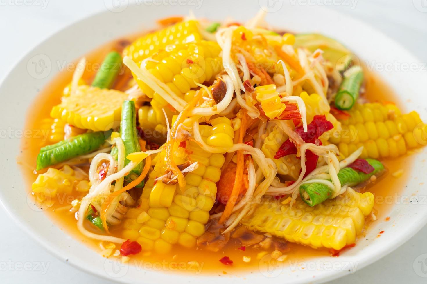 Som Tum - Thai spicy papaya salad with corn photo