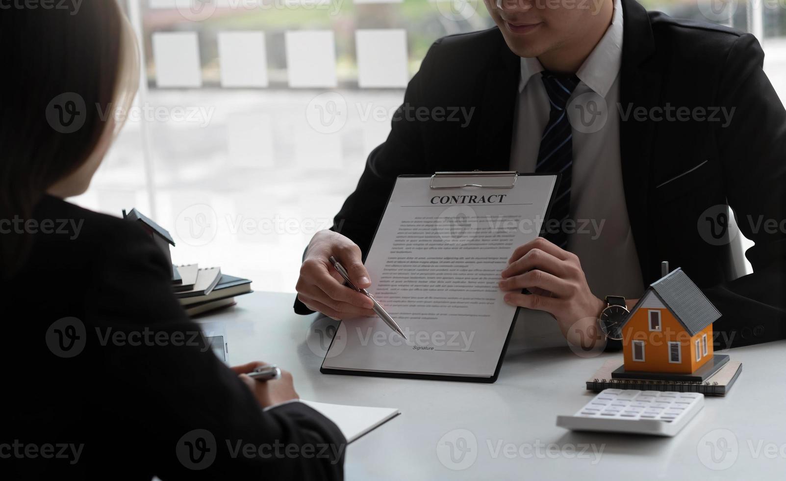 Real estate agent to buy house and land are delivering house to customer after agreeing to make a home purchase agreement. photo