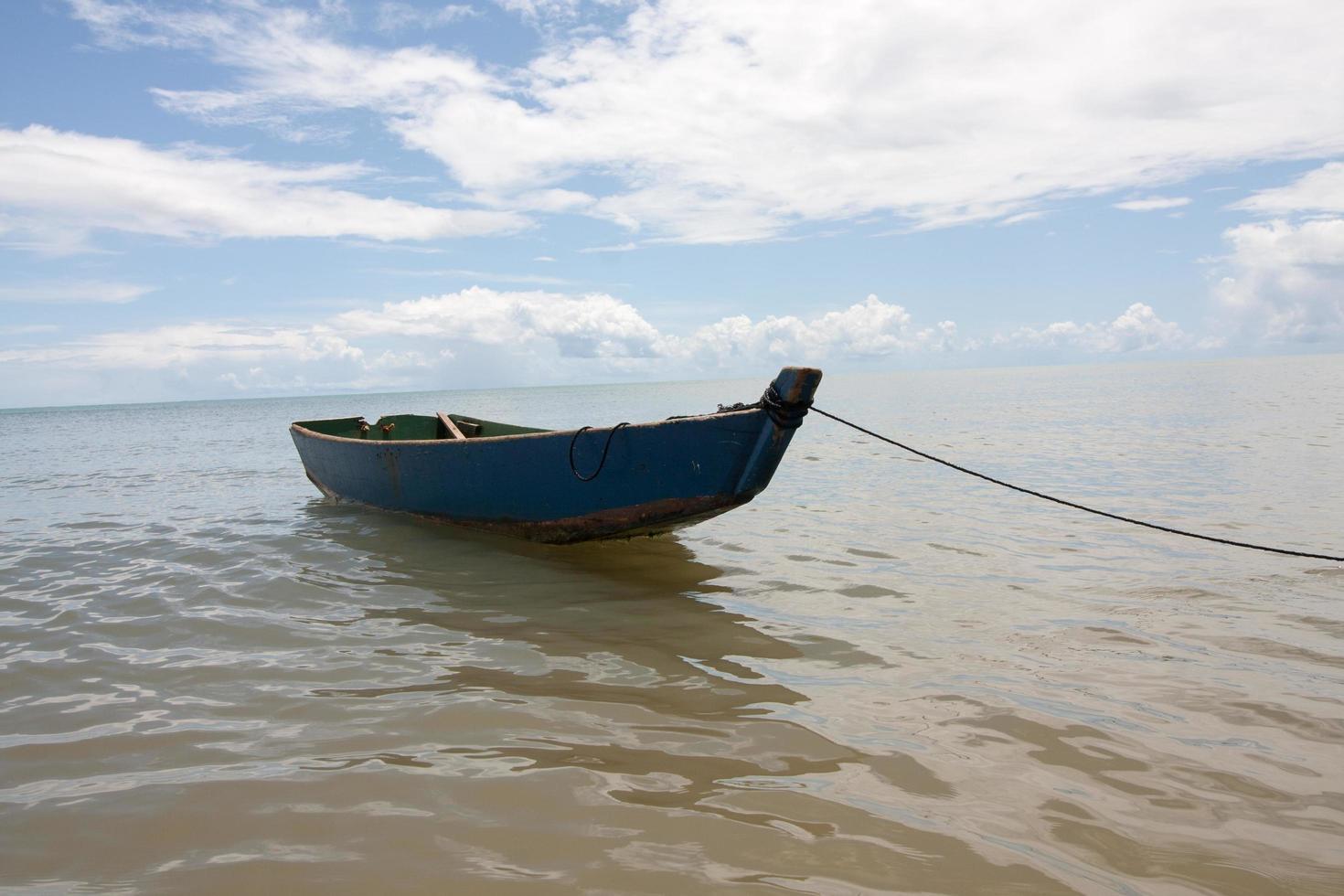 Small wooden fishing boat left anchored near the beach in Ponta do Corumbau photo