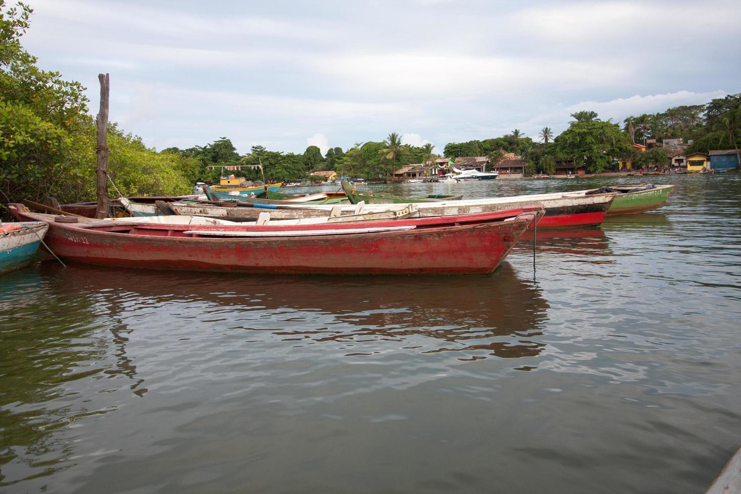 Caraiva, Bahia, Brazil, March 6 2022 The small crickady wooden boats used to ferry people and tourist arcos the river caraiva to the small town of Caraiva photo