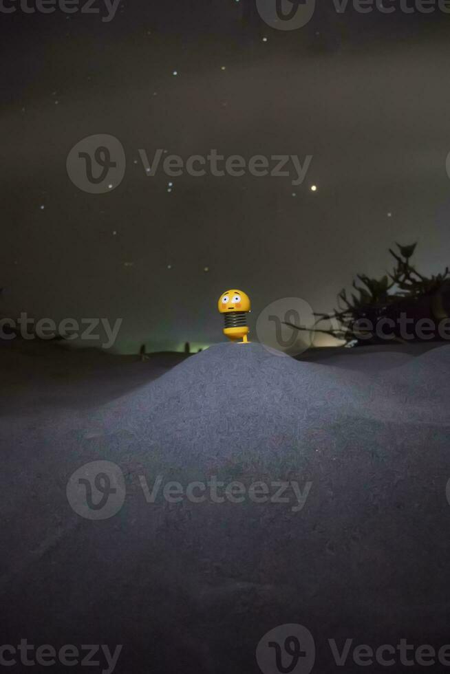 A toy with stars in the background at night photo