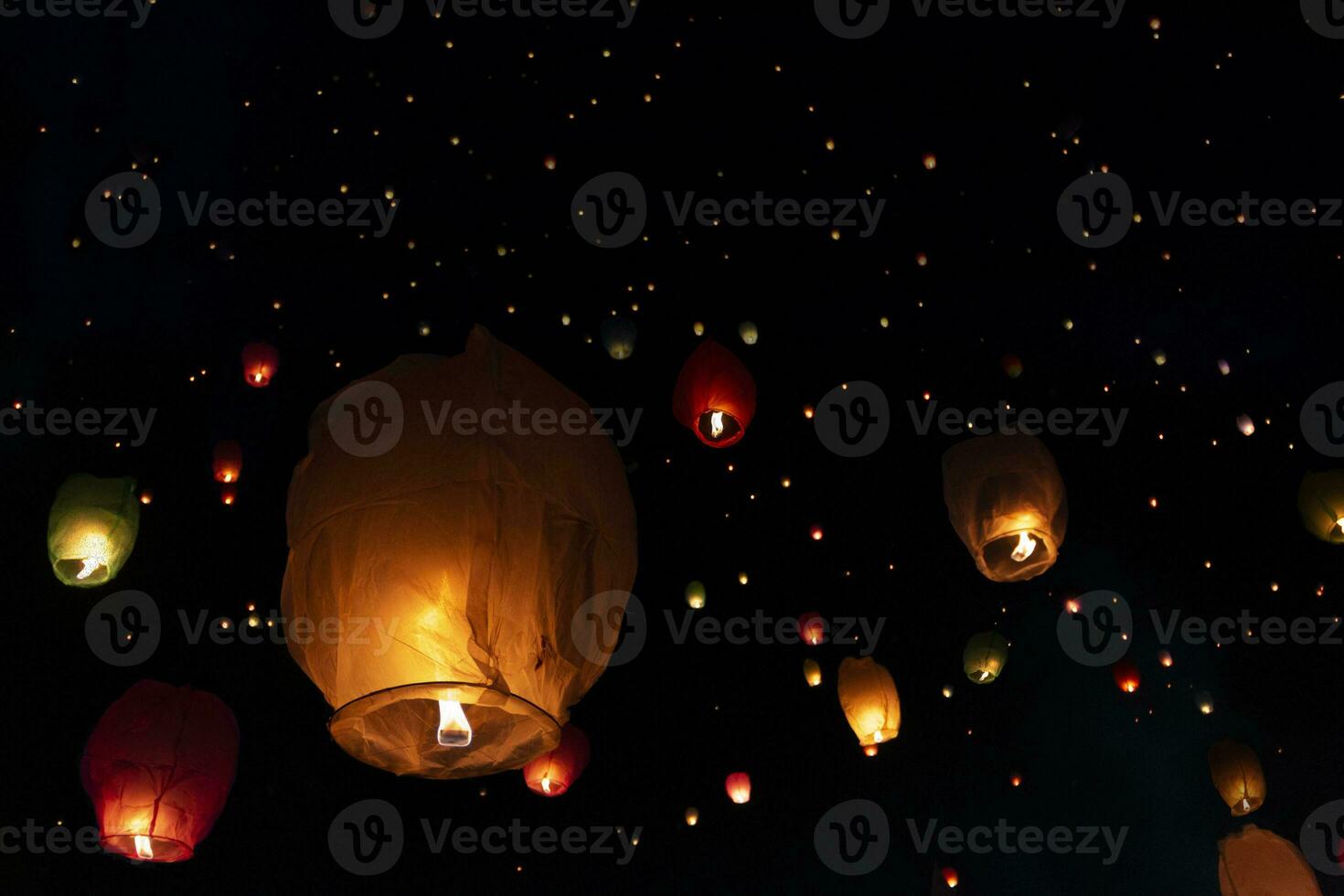 Lanterns fly in the night sky photo