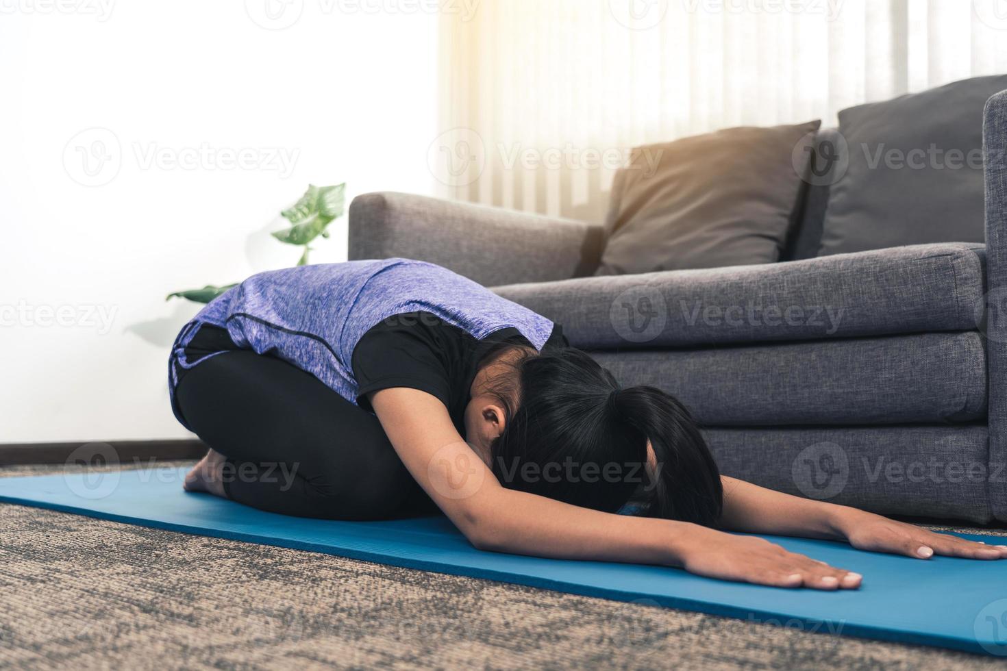 Asian women do stretching exercises after taking yoga classes while at home. photo