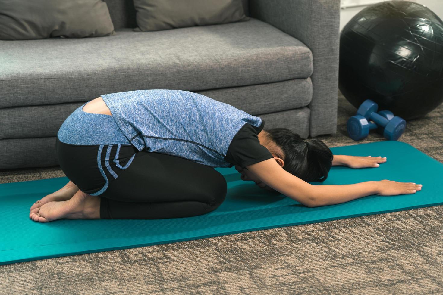 Asian women do stretching exercises after taking yoga classes while at home. photo