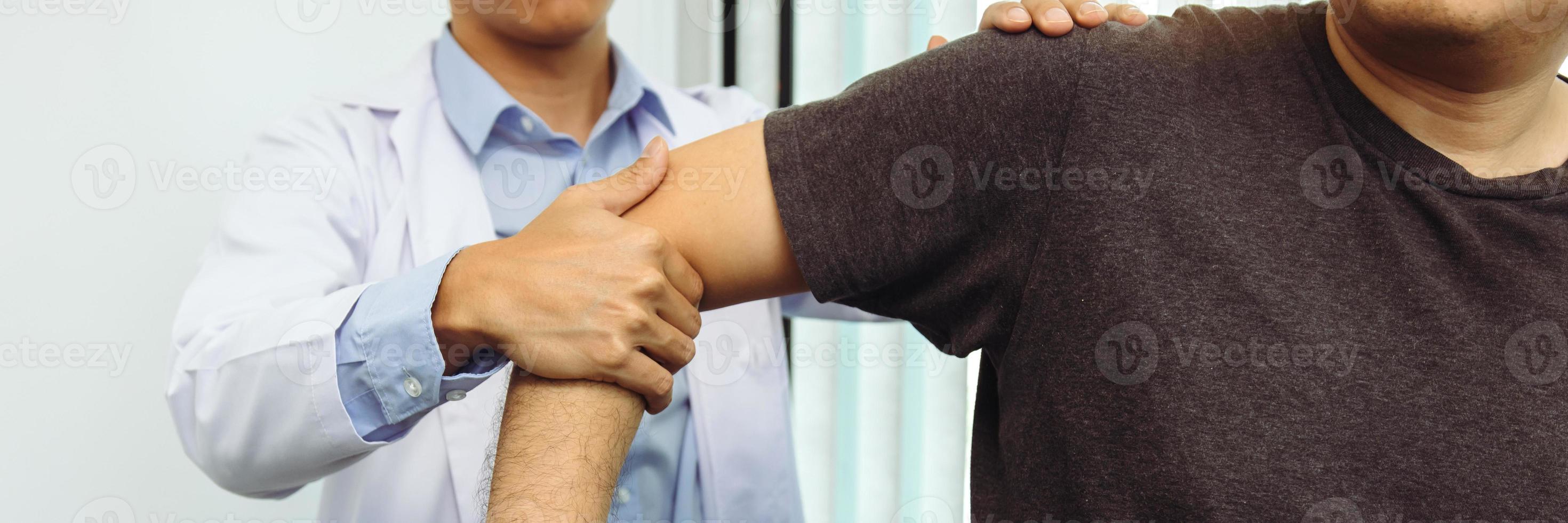 Physical therapists press to the patient shoulder check for pain. photo