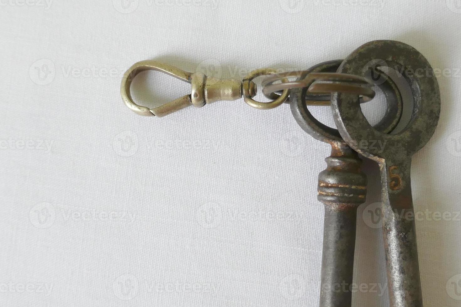 Old Iron Keys and Keychain against White Background photo