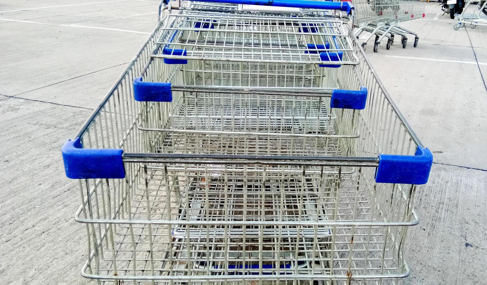 Empty supermarket shopping carts outside in the parking lot photo