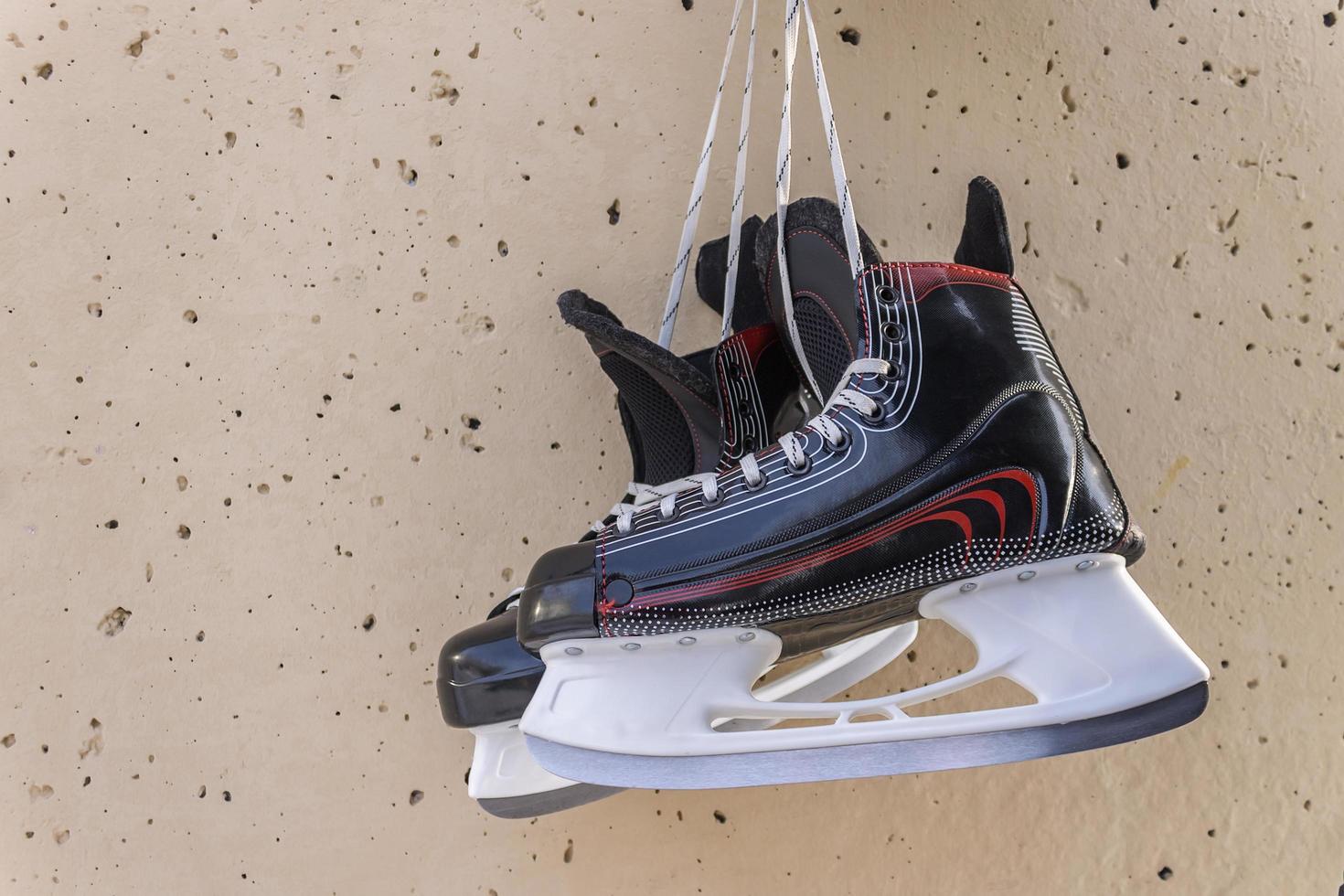 Winter skates hang on the wall as a symbol of career completion photo