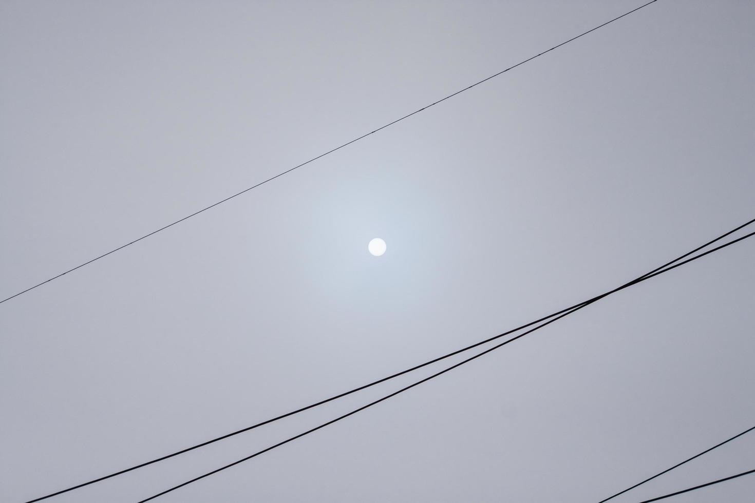 High voltage wires against a cloudy sky. photo