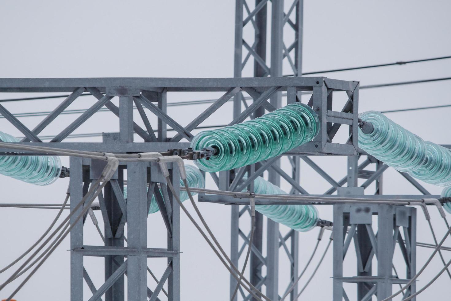 High-voltage line insulators at an electrical substation. Electric power elements of urban infrastructure. photo