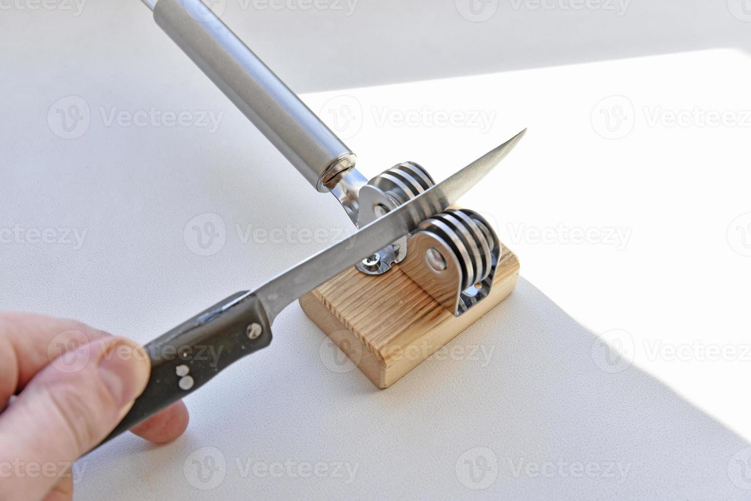 Closeup man hands sharpen knife on whetstone sharpener or grindstone.  Concept, maintenance tools for cooking, make knife sharp ,not dull for long  live using. Original style. 17158382 Stock Photo at Vecteezy