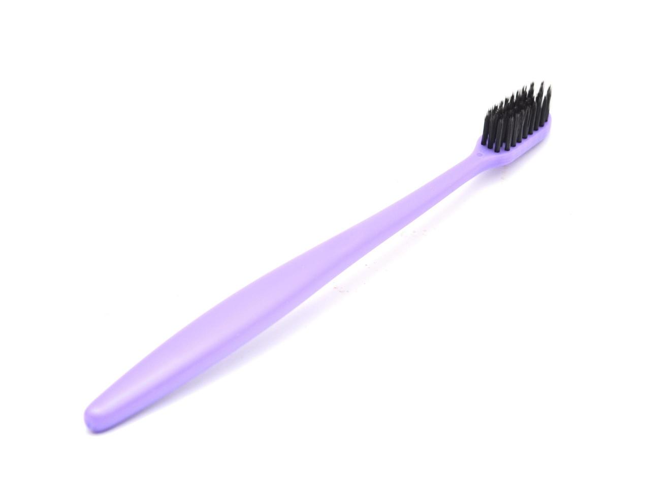 bright purple toothbrush isolated on white background photo