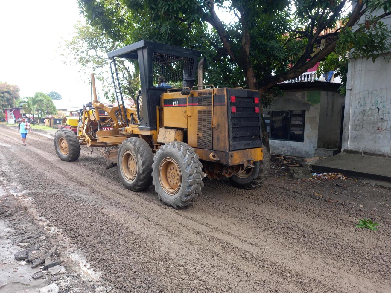 Medan, Indonesia, February 07, 2022-Grader leveling road for paving photo