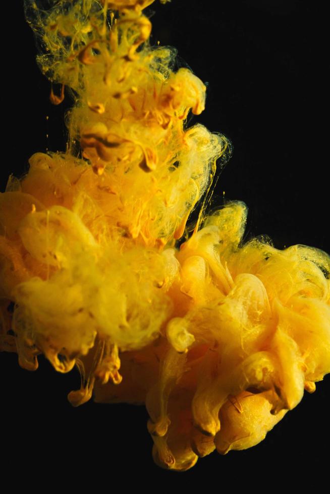 Yellow colorful ink drop in water, Ink swirling in. abstraction image for background or color referent. photo