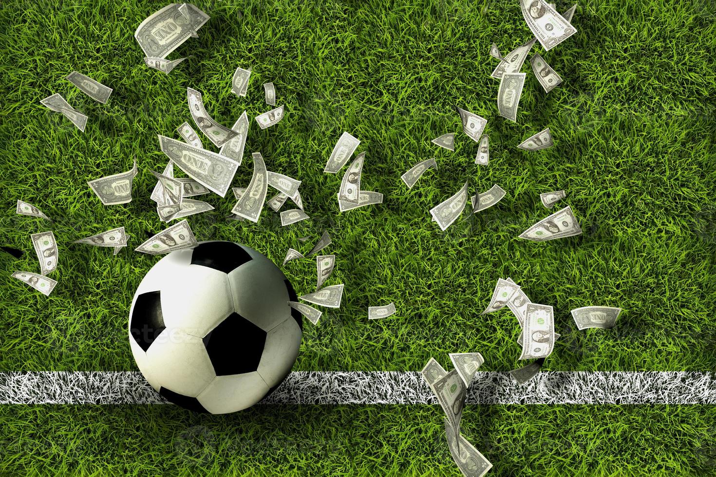 Soccer ball on green grass with dollar bills. Gambling ideas. photo