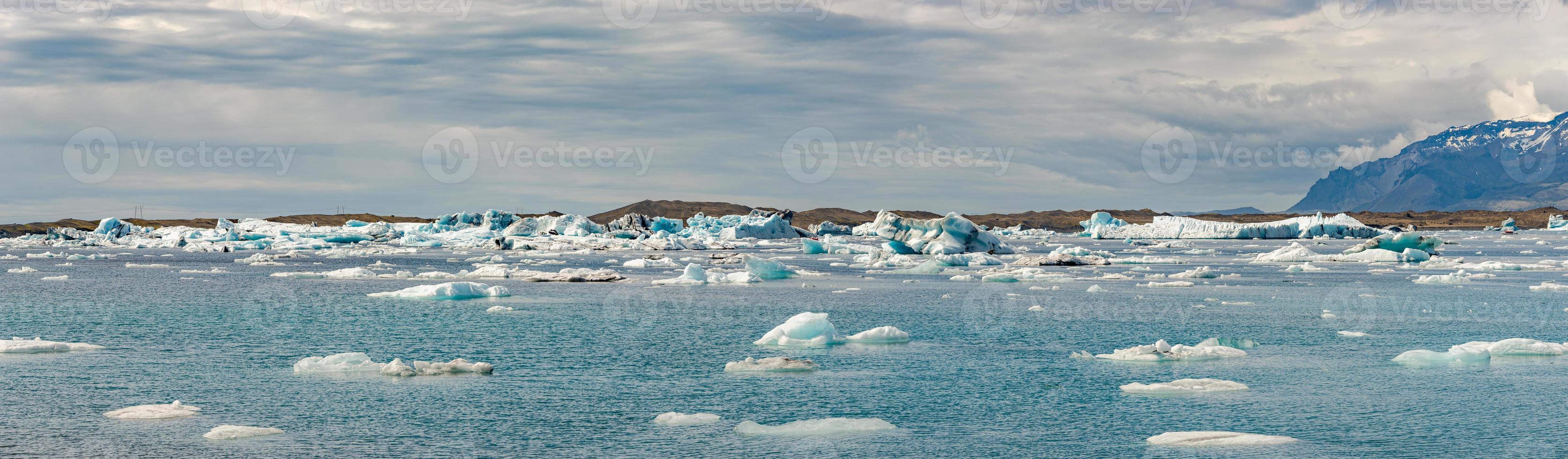 Panoramic view of Glacier Lagoon Jokulsarlon with icebergs and Vatnajokull Glacier tongue, Iceland, summer photo