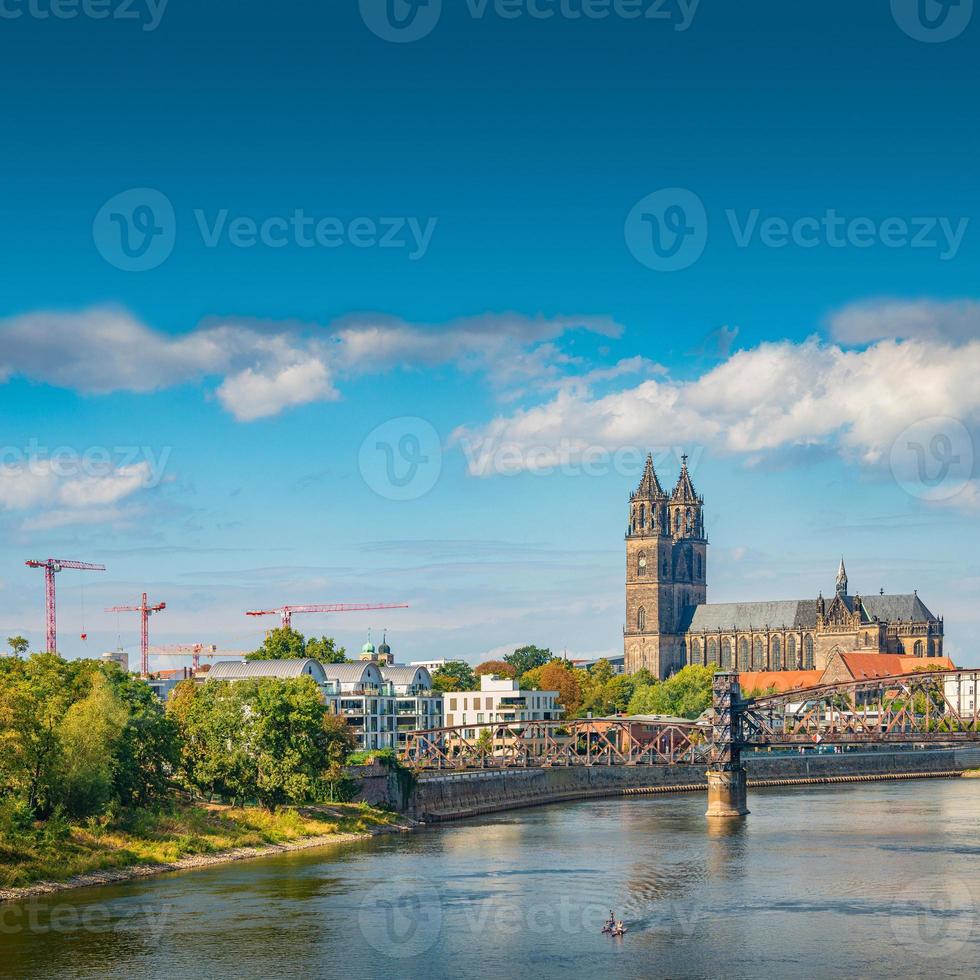 Cover page with Magdeburg historical downtown, Elbe river, city park and the ancient medieval cathedral in Spring colors at blue cloudy sky and sunny day, Magdeburg, Germany. photo