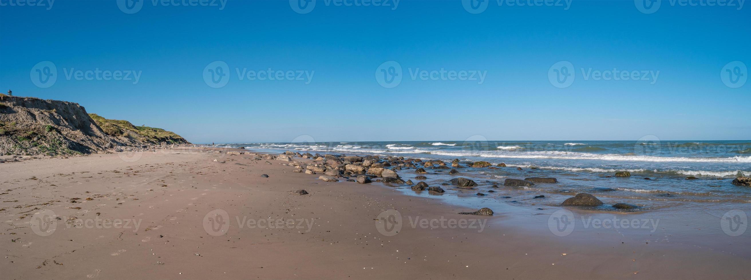 Panoramic view over seashore, beach and lighthouse in Hirtshals, Denmark, summer, at blue sky and sunny day. photo