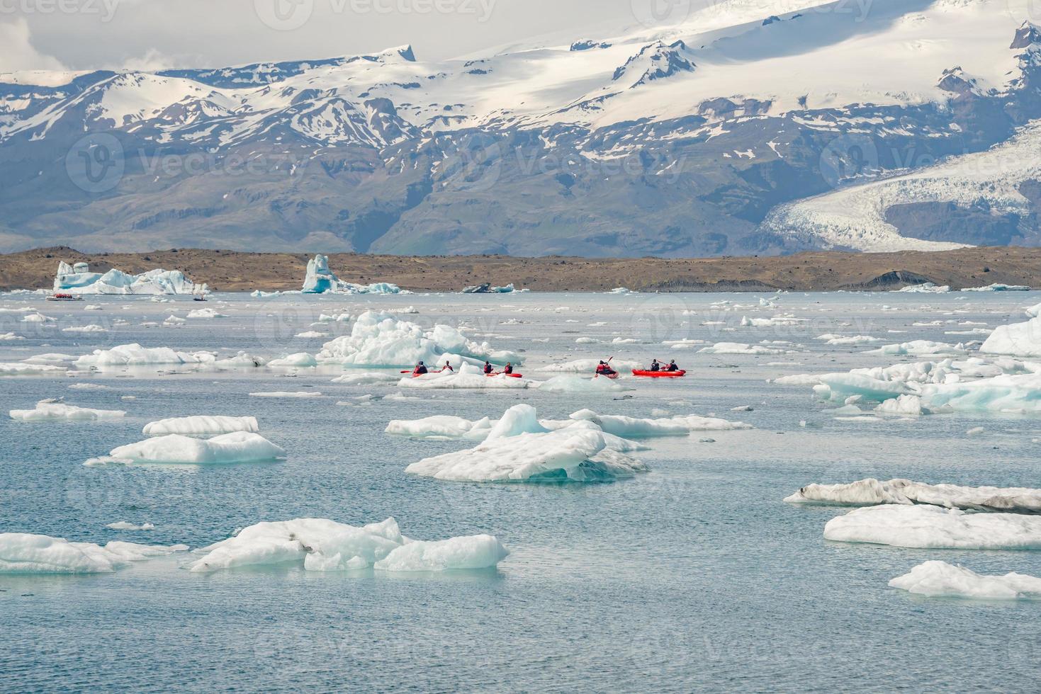 Panoramic view of Glacier Lagoon Jokulsarlon with icebergs and Vatnajokull Glacier tongue, Iceland, summer, with a touristic kayaking and people. photo