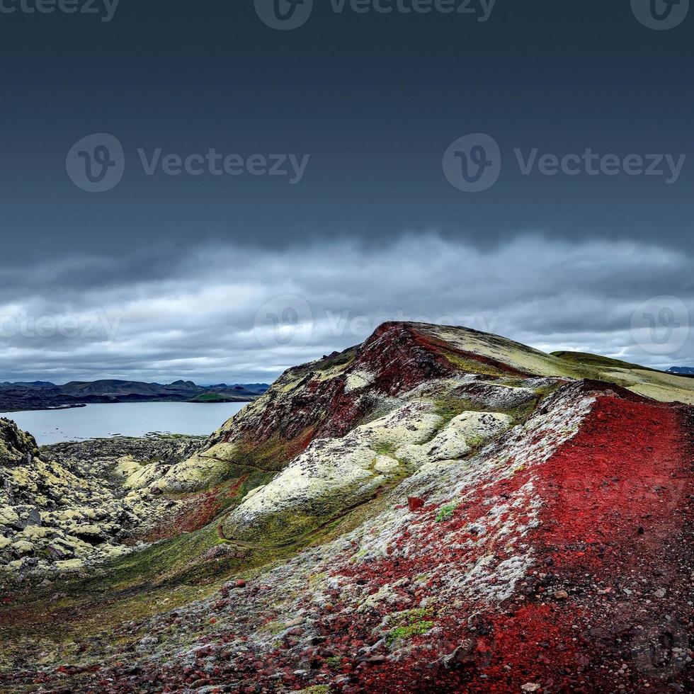 Landscape view of colorful rainbow volcanic Landmannalaugar mountains and famous Laugavegur hiking trail, with dramatic sky and snow in Iceland, summer photo