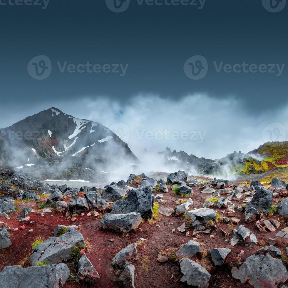 Landscape view of colorful rainbow volcanic Landmannalaugar mountains and famous Laugavegur hiking trail, with dramatic sky and snow in Iceland, summer photo