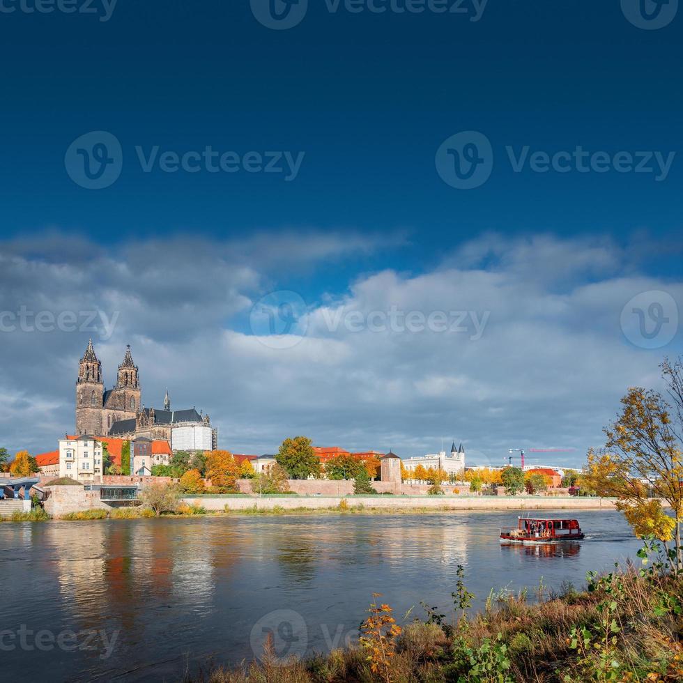 Cover page with Magdeburg historical downtown, Elbe river, city park and the ancient medieval cathedral in Spring colors at blue cloudy sky and sunny day, Magdeburg, Germany. photo