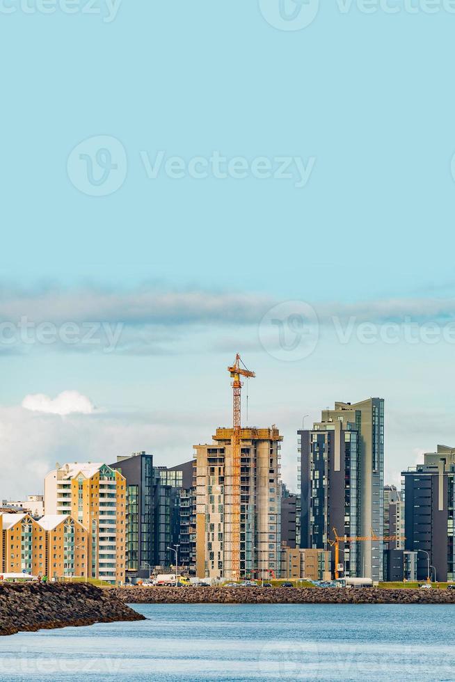 Cover page with historical modern downtown in Reykjavik and construction sites for new skyscrapers, at Summer in Iceland, dramatic scenic view at sunset with copy space and solid background. photo