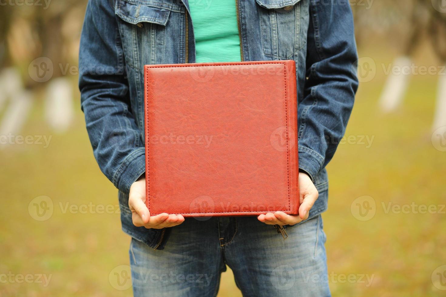 square photobook in his hands. Wedding photo album