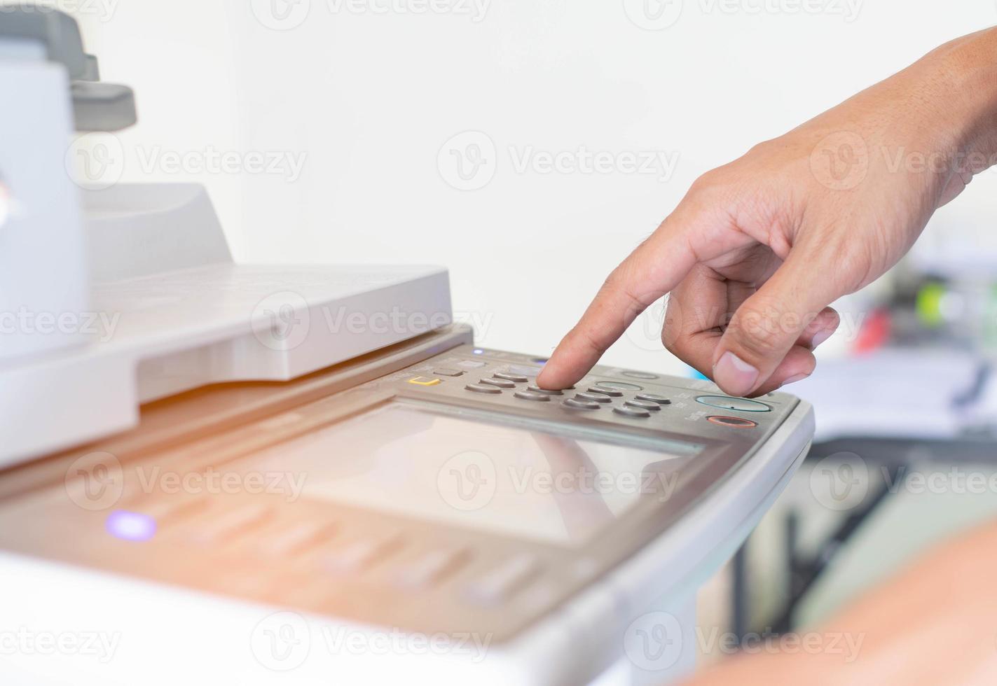 a man is pressing the botton of printer photo