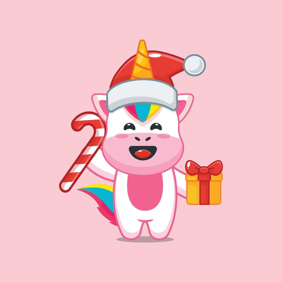 lindo personaje de dibujos animados de unicornio con dulces de navidad y regalo vector