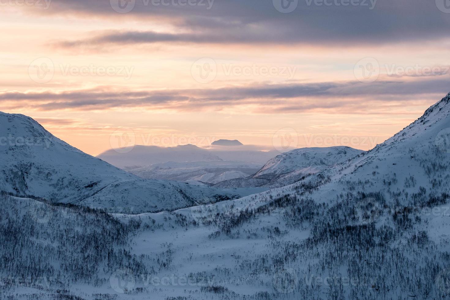 Scenery snowy mountain range with colorful sky on peak photo