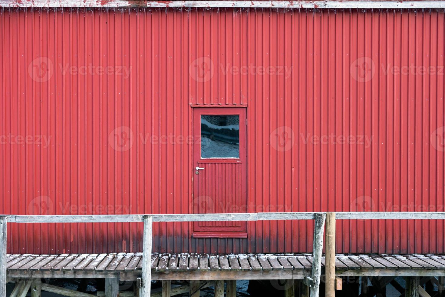 Metallic door and wall of warehouse on coastline in fishing village photo