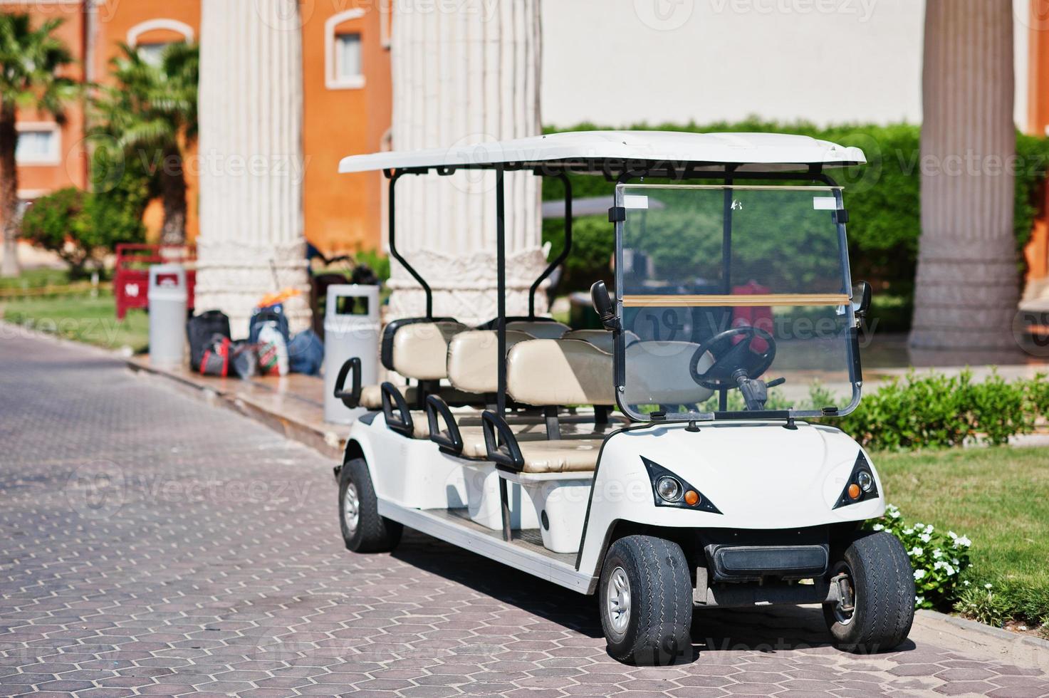 White golf car with back seat on resort. photo