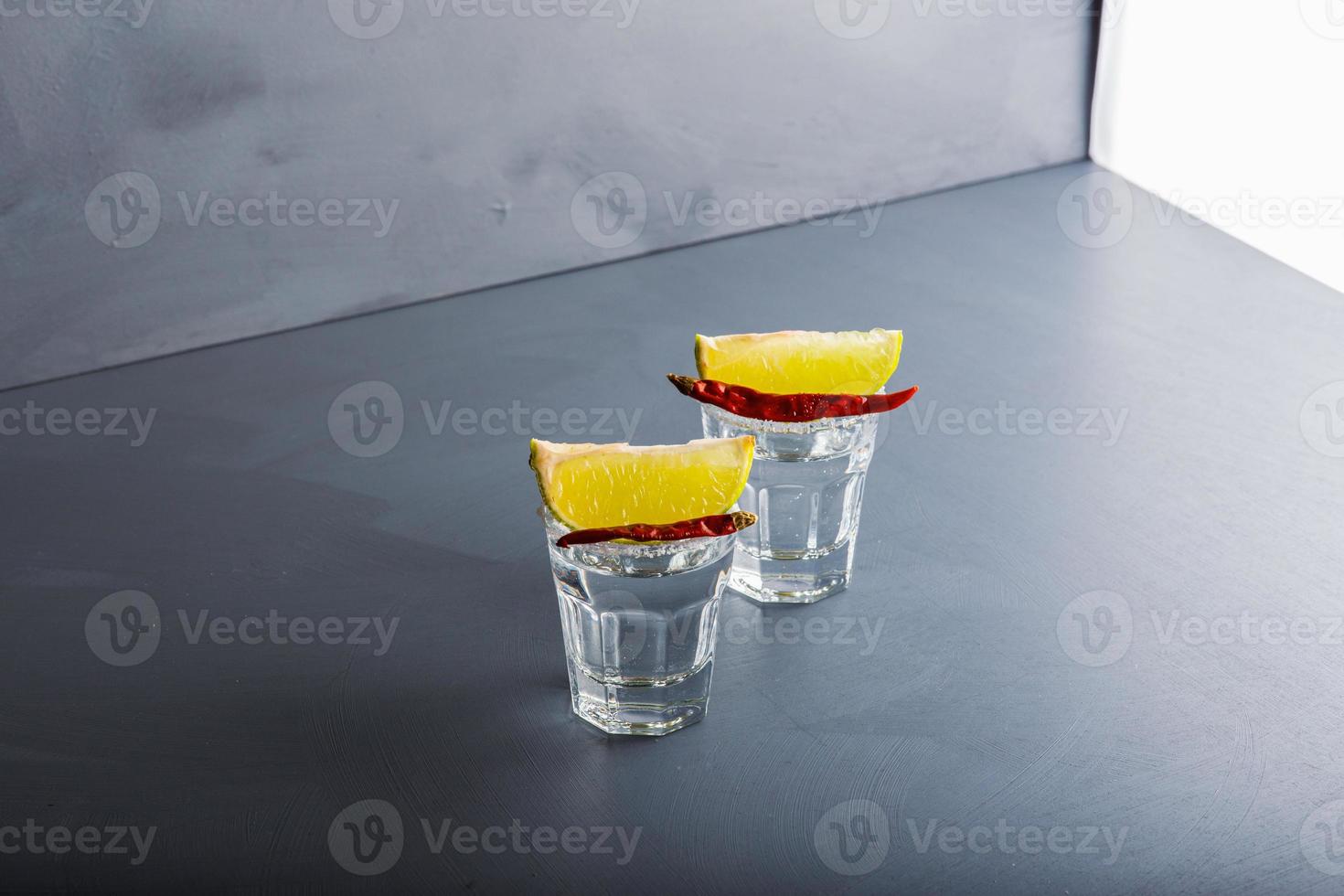 Closeup detail view of tequila shots from studio with copy space. photo